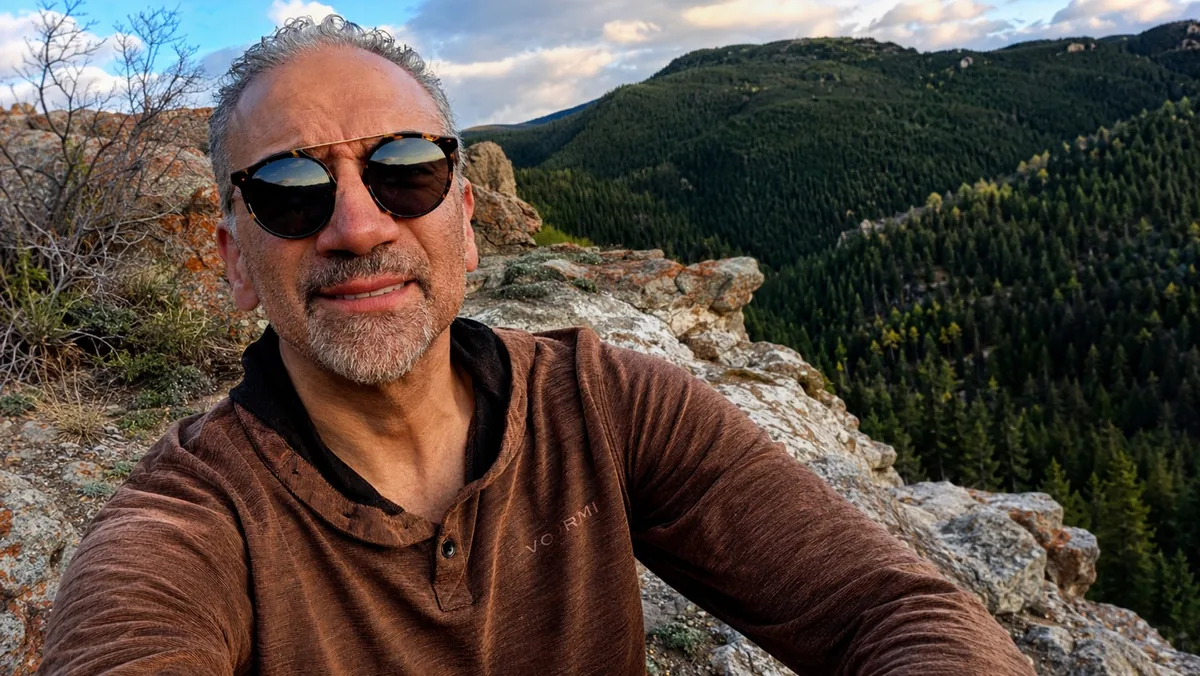 Dr. Brett Kessler outdoors on a mountain ridge.