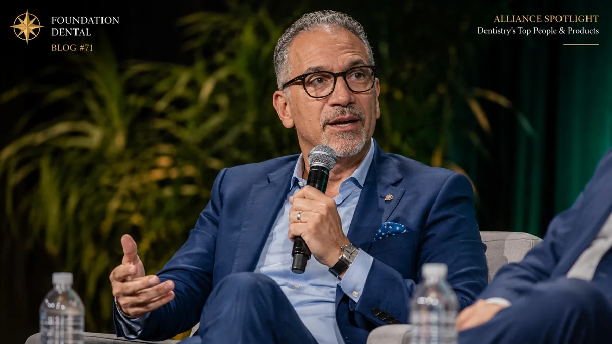 Dr. Brett Kessler speaking with a microphone at a panel discussion.