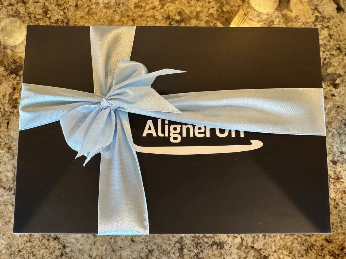 An AlignerOff gift box tied with a ribbon.