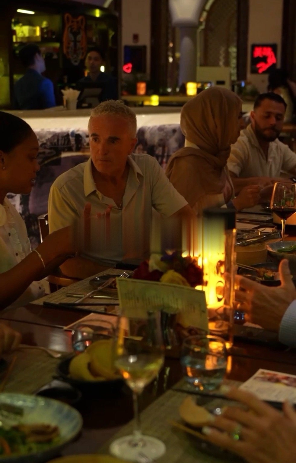 Retreat attendees in conversation over dinner at a Dubai restaurant