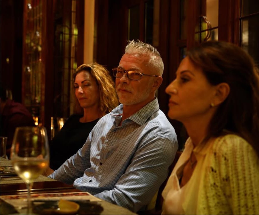 Dr. Jim Arnold at an intimate candlelit dinner with retreat guests