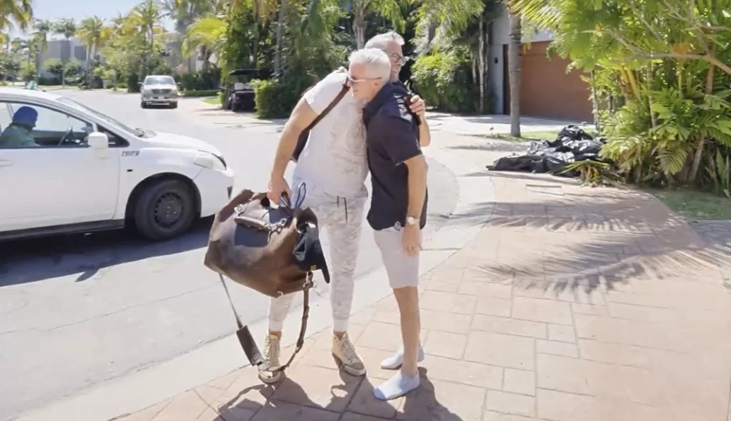 Two dentists embracing on the driveway on arrival day