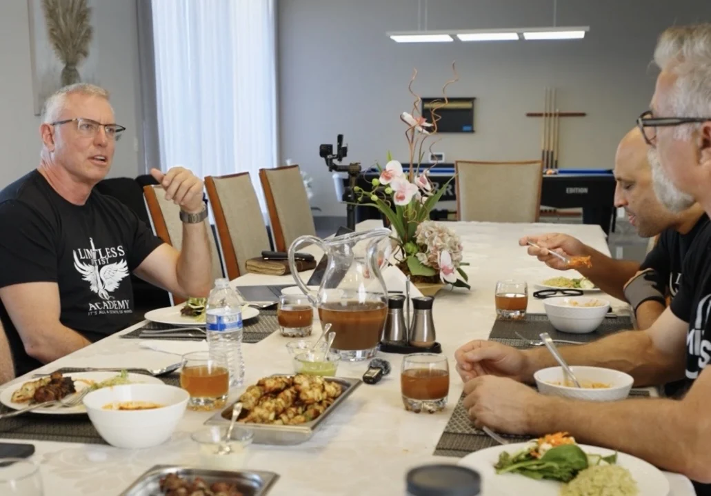 The group eating and talking along the long dining table