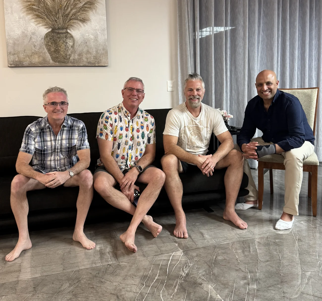 Four dentists seated together on the couch