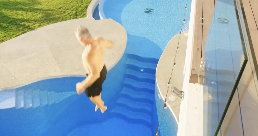 A dentist mid-air above the pool