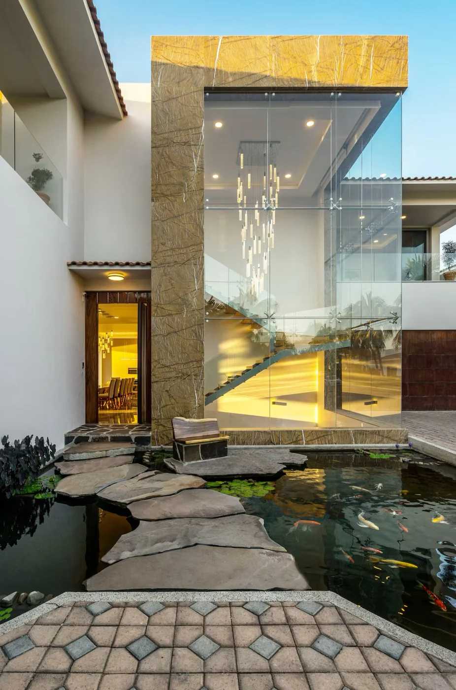 The koi pond and glass staircase entry of the mansion