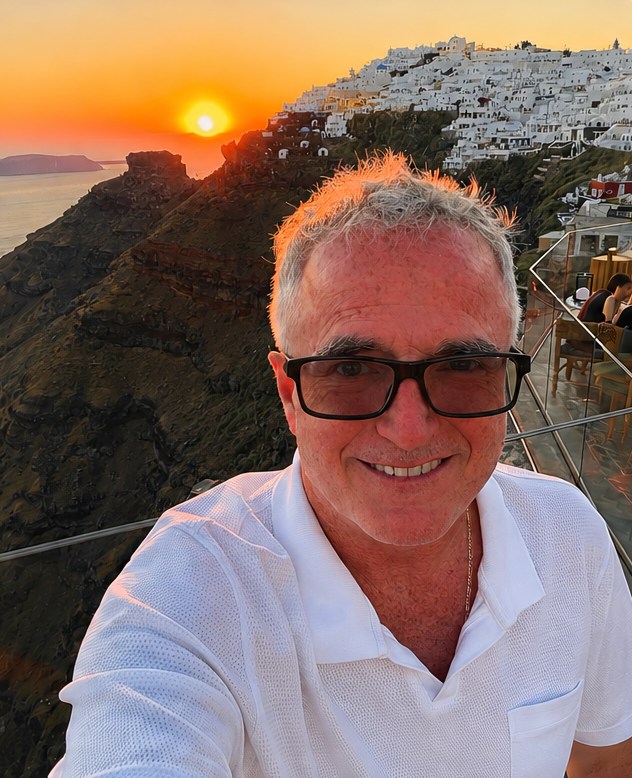 Dr. Jim Arnold on a Santorini terrace at sunset