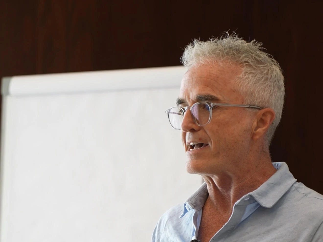 Dr. Jim Arnold leading a live implementation session at a whiteboard